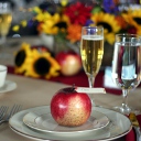 A single apple serves as the name tag holder on this table.