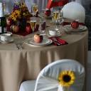 This summery table is decorated with festive flowers and apples.